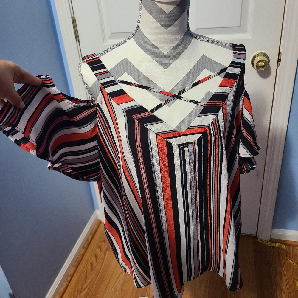 Multi color stripped cold Shoulder top. Has criss cross on front.